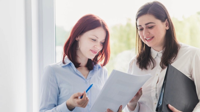 Two colleagues reviewing a document together